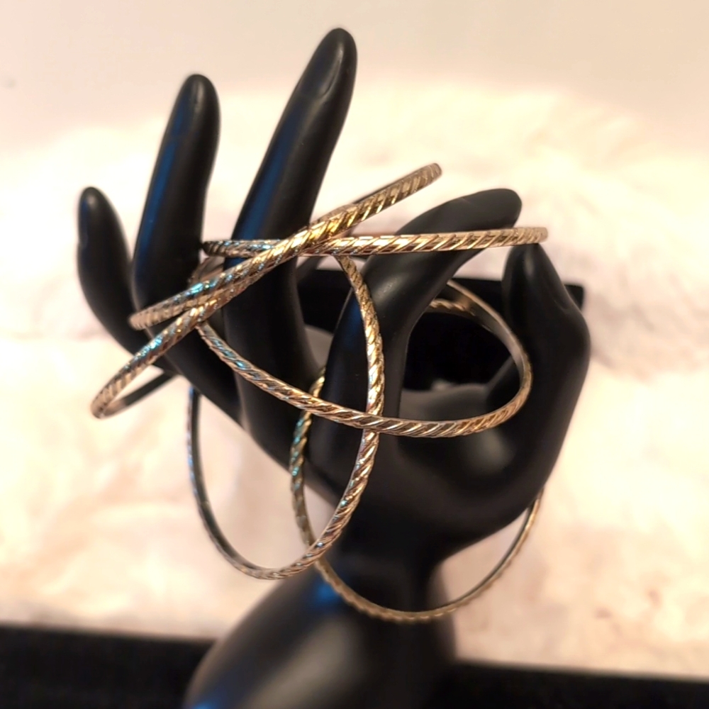 Six Gold Toned Textured Jingle Bracelets